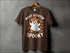Brown T-shirt featuring Boot Scootin Spooky Ghost graphic with cowboy boots for Halloween