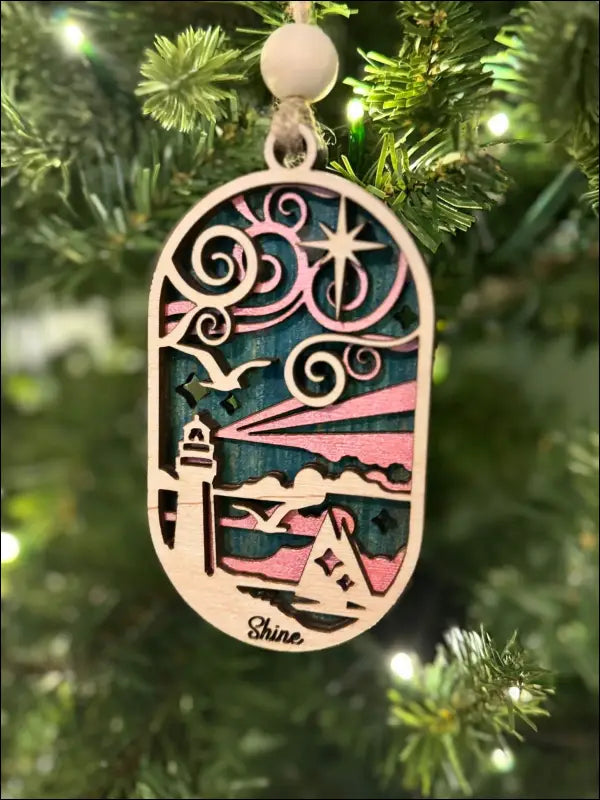 Layered wooden coastal scene ornament featuring a Coastal Lighthouse Ornament design