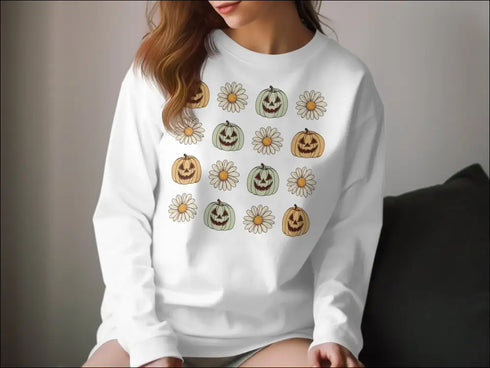 White sweatshirt featuring a pumpkin and flower pattern, perfect for Fall Halloween style