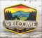 Hand painted rustic welcome sign featuring a mountain scene for outdoor door decor