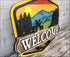 Hand painted rustic welcome sign featuring a mountain scene for handcrafted door decor