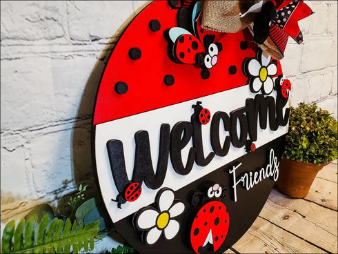 Hand painted door hanger featuring a ladybug and daisy design for welcoming friends
