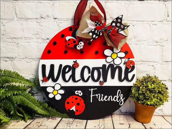 Hand painted door hanger with ladybug and daisy design for welcoming friends