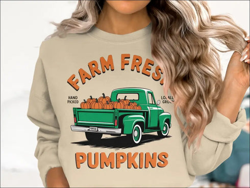 Beige sweatshirt featuring a green truck and hand-picked farm fresh pumpkins design