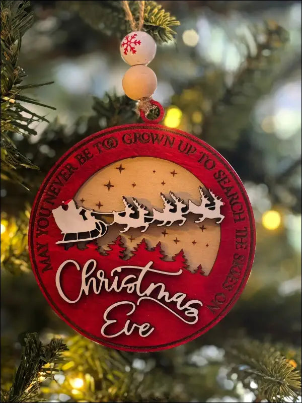 Red Christmas ornament featuring Santa’s sleigh in handmade wooden design for personalized holiday decor