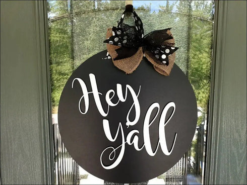 Black round door hanger with a bow for rustic home decor and housewarming gift