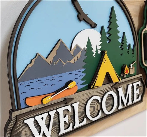 Layered wooden camping welcome sign featuring handpainted mountain scene art for rustic outdoor decor