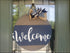 Round welcome sign with bow, perfect as a customizable porch decoration or door hanger sign