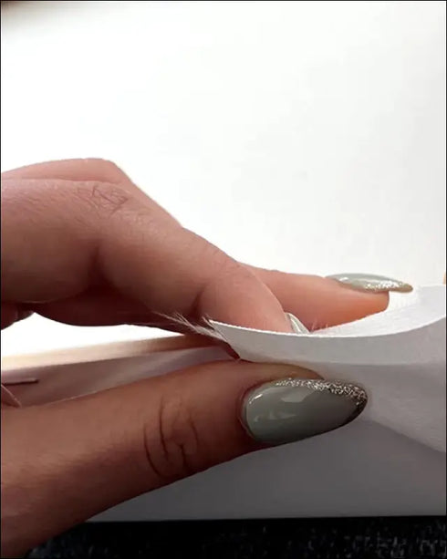 Hand with glittery silver nails holds ocean love runs deep canvas print edge