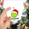 Lime green golf ball Christmas ornament with Santa hat design on high-quality white ceramic background