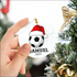 High-quality white ceramic soccer ball ornament with Santa hat design on white background