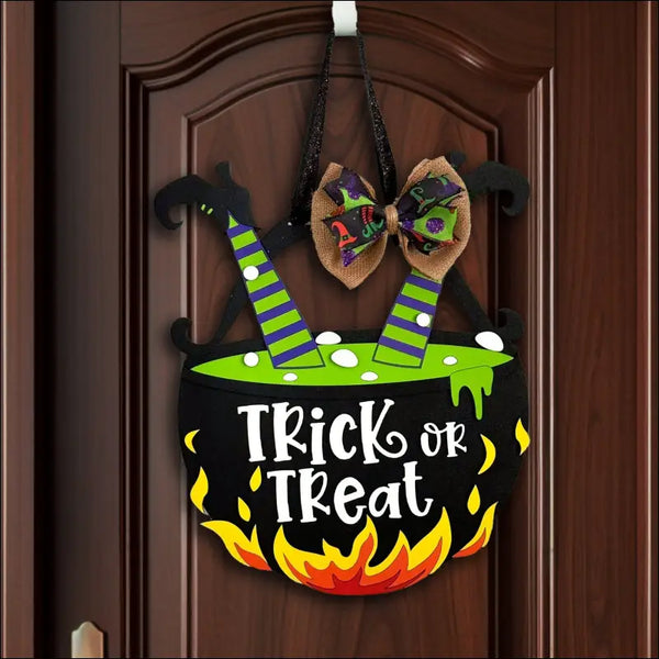 Halloween cauldron door decoration featuring a handpainted wood treat door hanger sign