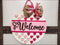 Valentine’s Day door hanger sign with hearts and bow, perfect rustic wall decor