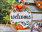 Round Welcome Pumpkin Wood Door Hanger with decorative bow for rustic farmhouse entryway