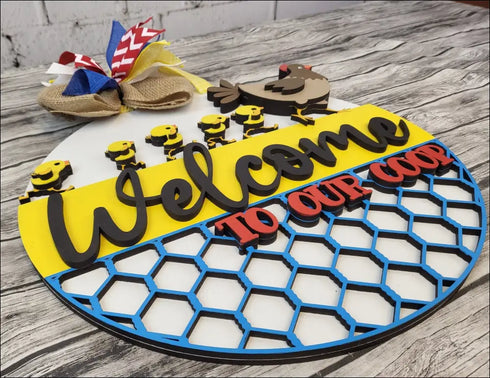Decorated Welcome to Our Coop sign for farmhouse chicken decor and handpainted wood door