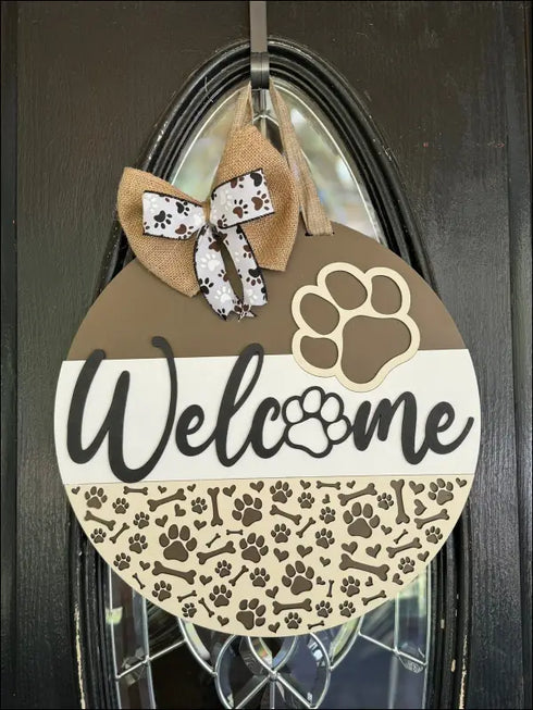 Round wood door hanger sign featuring a paw print design for dog lovers